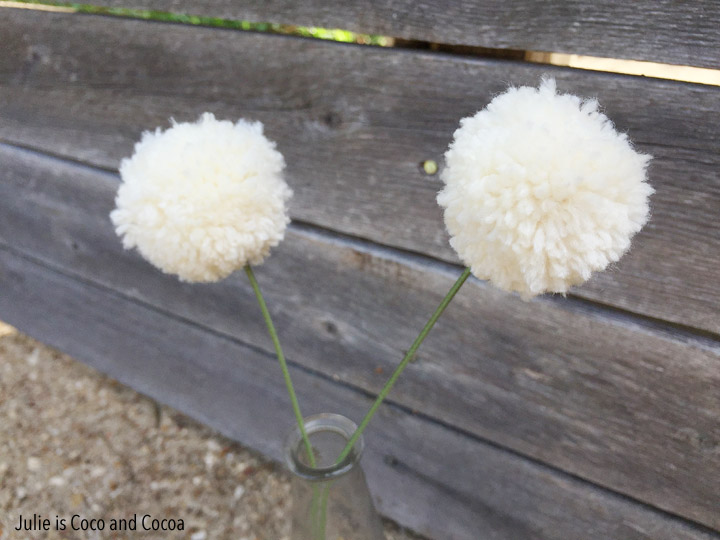 Easy Yarn Crafts from Julie is Coco and Cocoa. Yarn Pom Pom Flowers and Tassel Wall Hanging